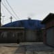 This is the building you want to run to at the beginning of the match. It's at the end of the street on the right.