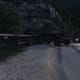 This flatbed trailer is on the left side of the road just after cross a metal bridge. Block the RV by positioning your Sandking like that.