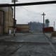 The yard with the last truck, guarded by armed gunmen.