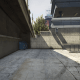 Climb over this wall, past the gate, at the East end of the police station (the second vehicle B).
