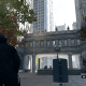 The Crowley Building courtyard. Notice how Ubisoft added in a bunch of brush (and there's like a car dealership behind where Aiden's facing). In real life it's just a very wide expanse of cement. Nothing wrong with that though!