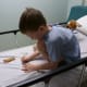 Playing with crayons and stickers before his tonsillectomy.