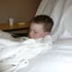 Lying in the hospital recliner after surgery, feeling very poorly.