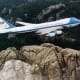 A Presidential VC-25A flying over Mt. Rushmore.