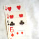 The wild two (a joker could also be used) makes the first canasta dirty, and worth only 300 points. The addition of a 6 in the second image makes the canasta clean.