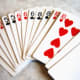 Player draws two from the deck in the center of the table. Lucky draw! Player can meld the entire front hand, and discard the ace into the pile.