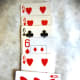 Help your teammate keep track of which canastas are ready to close by laying one card horizontally across the bottom of the canasta book that needs its final card.