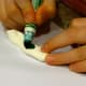 Take a marker and color all over the model magic. Use a lot of marker, as it sinks in quickly. If your model magic is pre-colored, mix the colors together to get the shade you want.