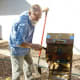 Cranking the bellows and shaking the riffle box.
