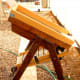 Opposite side of the pulley and crank. Notice the little black rod top left. That is what controls the trap which adjusts the amount of material from the hopper that is allowed to drop down. In the photo it is closed.