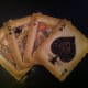 A decoration showing four playing cards. Decorations like this can be used in playing card collections.