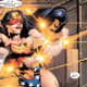 A blind-folded Wonder Woman deflecting a barrage of bullets with her magical bracelets.