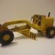 1964 Tonka mini-grader. Tonka also released 'mini' toys in the early 2000s, but those are truly minis—around 3–4 inches long. The 1964 version is almost a foot long.