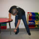Gently swing your arm in small movements to mobilize the shoulder joint. Do this by moving at hips and knees.