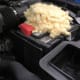 Mouse nest built on top of a car battery
