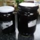 The essential eucalyptus oil in the measuring jug is poured into jars for storage and eventual use.
