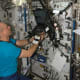Expedition 15 Flight Engineer Clay Anderson works with a Continuous Blood Pressure Device (CBPD) and computer.