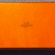 Real Hermès tie boxes are a distinctive bright orange. Fakes will be off-color and may not have the same font on the printing. This one is legit!