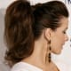 Back-brushed hair on top of head with volume and save in high ponytail.