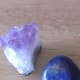 Amethyst and lapis lazuli. The amethyst is shown here as untreated (top left) and polished forms (bottom left.) This lapis was polished and tumbled.