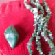 These stones have all been polished. The larger piece is a loose tumbled stone, the small ones only polished and now a necklace. Beads are often sold in these two forms. These forms can be found at wholesalers or retail gift shops.
