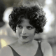 Clara Bow with a short, curly bob.