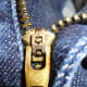 Adriano Goldschmied AG logo stamped on zipper slider