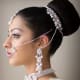 Flat-front hairdo with a big high hair bun for hanging the wedding dupatta.
