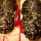 Gorgeous low hanging hair updo with a heavy hair bun resting at the nape of the neck.