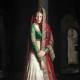 This is an A-cut lehenga skirt in off-white, green and red.