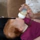 Keep the bottle tilted up, so she doesn't get air when she sucks.