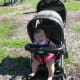 The Baby Trend Double Stroller moves well over grass or mulch, as in this park.