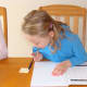Grace writes in her notebook.