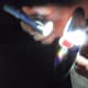 Hold the flashlight about an inch from the CD.