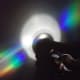 A rainbow reflecting on each side of the CD.