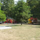 This school playground has a natural play area and a traditional play area, but even the traditional play area is surrounded by trees.