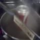 Place the can, open end into the bubbling water supported by tongs.
