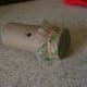 A toy kazoo, made from a toilet paper roll.