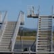 "How do I get on and off the plane?" At most airports you walk along a hallway and then step through the plane's door. At some airports, you'll use stairs to reach the plane's door.