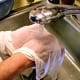 Scrub the towel together to loosen other cheese particles, and rinse most of the whey out. Wring out well.