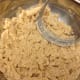 Cut butter into flour and sugar mixture with pastry blender.