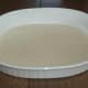 Ladle thin layer in bottom of casserole dish