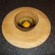 The egg is firstly broken into a small cup or bowl.