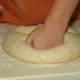Punch down the risen dough.
