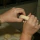 Form the bagel by gently turning and pulling the dough until a doughnut-like shape is achieved, about 2-3 inches across.