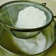 Sifting the dry ingredients into a separate bowl