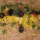 Next, add some cheese, cilantro, tomatoes and olives.