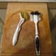 These are soft scrubbing brushes used to clean the pans after use with the help of hot water. No soap required!