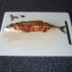 Spreading red pesto sauce on the mackerel