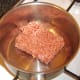 Beef is added to a dry pot.